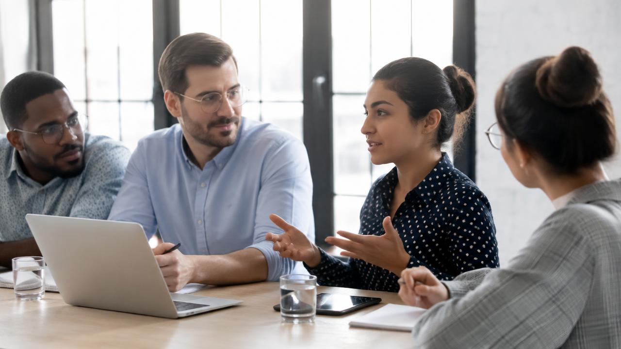 A person making a concise point while colleagues listen